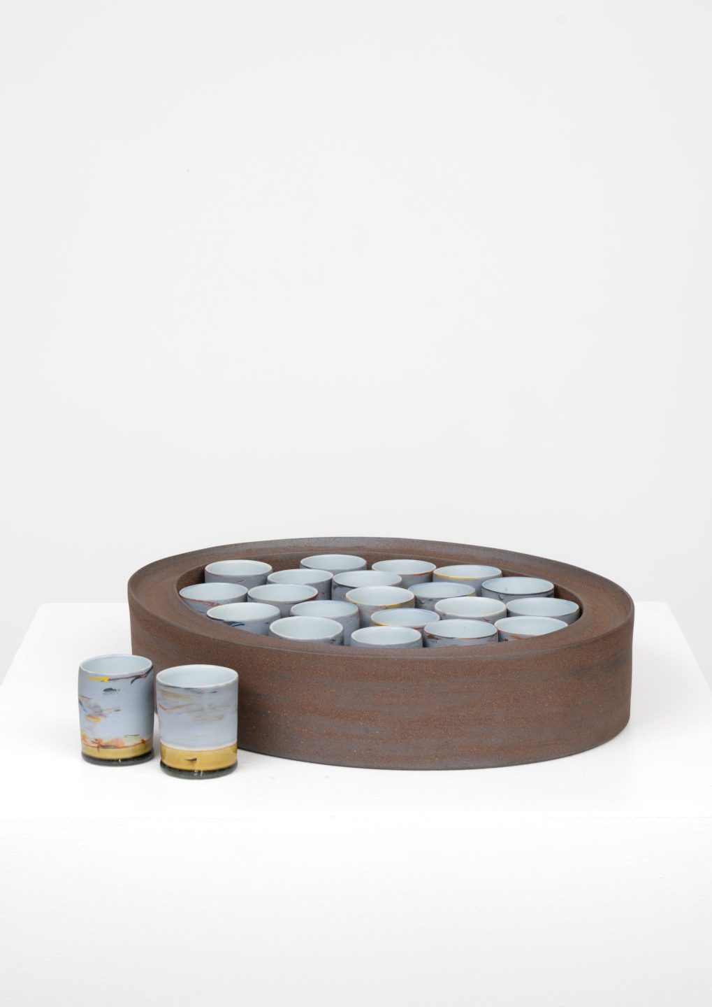 functional ceramic tableware including cups and vessels designed for dining